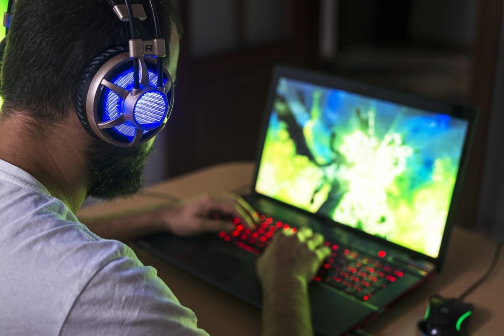 Man playing on gaming laptop