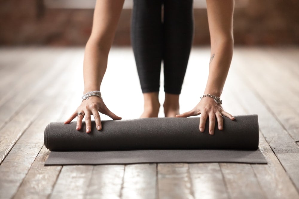 unrolling a yoga mat
