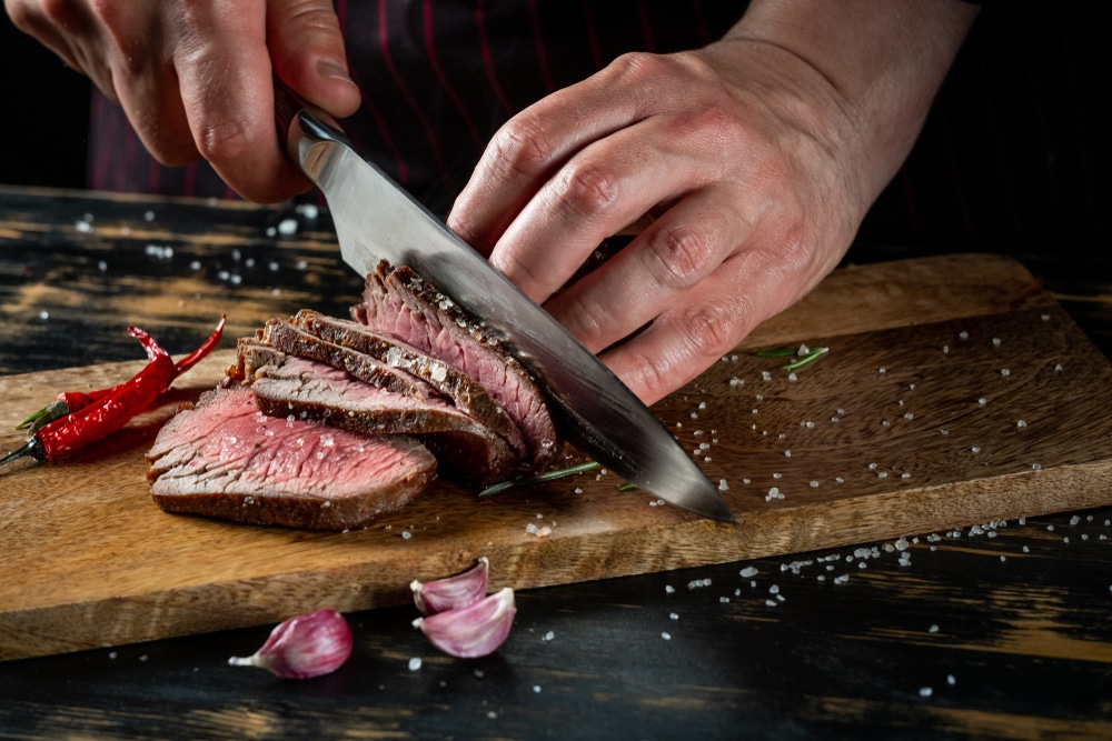 chef cutting beef steak